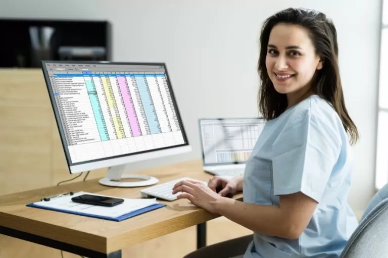 medical billing and coding tech trends. Medical biller/coder working at her desk.