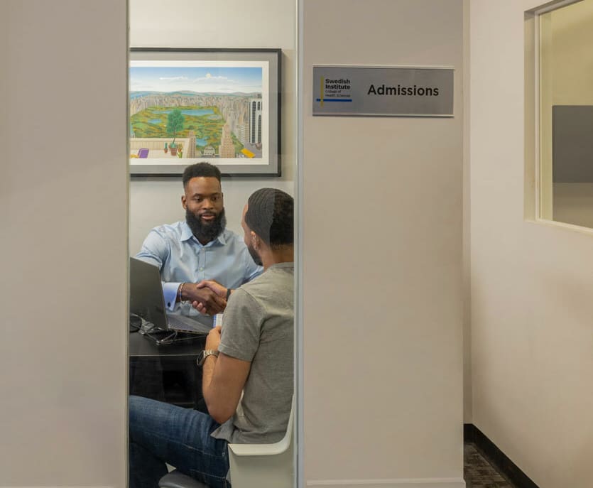 admissions counselor working with a new student