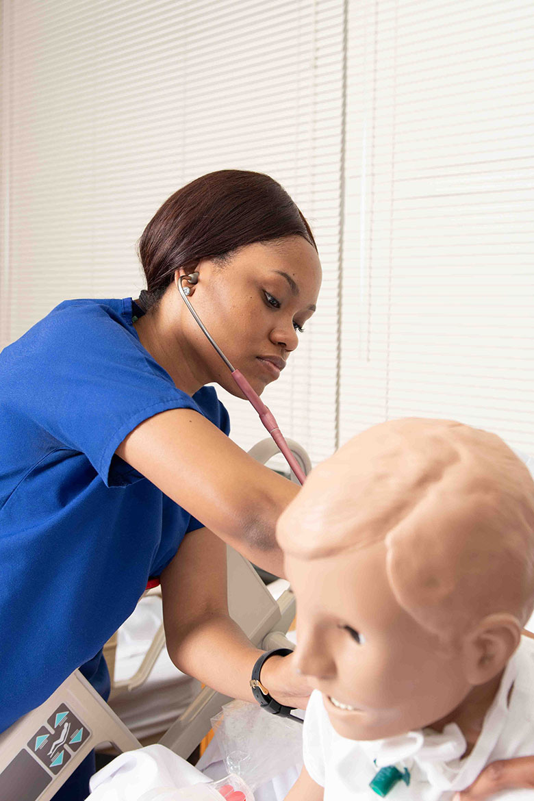 Female Nursing practicing on Patient Simulator - Swedish Institute - New York, NY