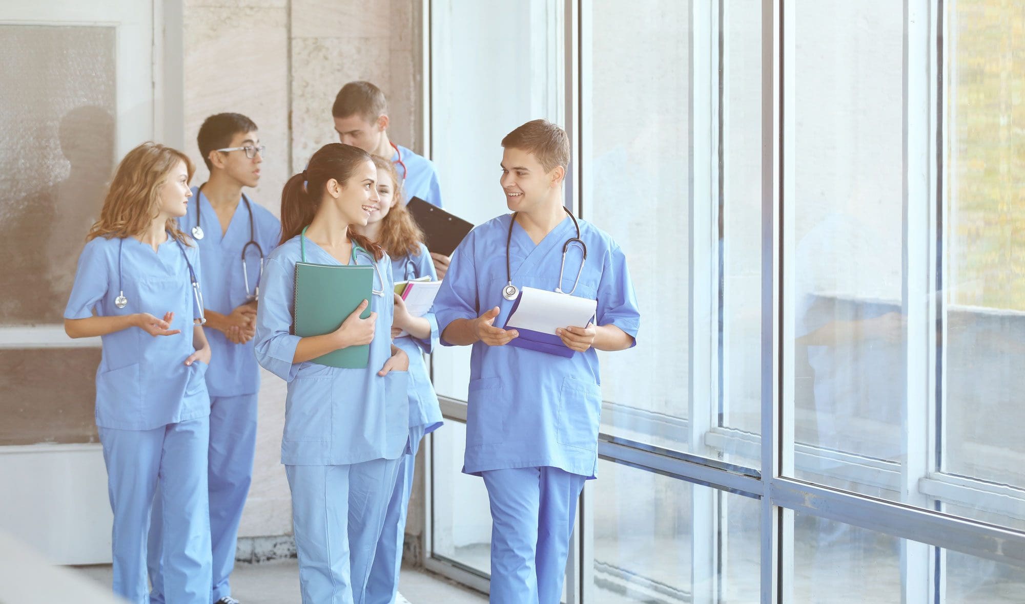 group of people in scrubs walking together